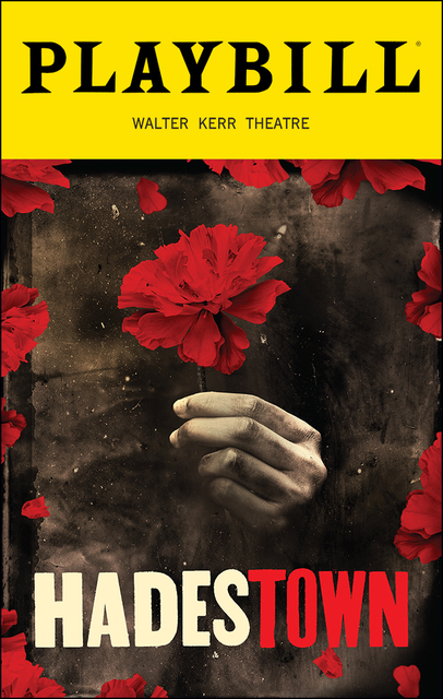 In black letters “Playbill” reads on the top of the picture with yellow behind it and in smaller font “Walter Kerr Theatre” below. The last three fourths of the playbill, bordered by red petals, features a hand poking out from smoke and ash holding a single red flower unscathed, the bottom fourth reads “Hadestown” with the “Hades” in white and “town” in red.
