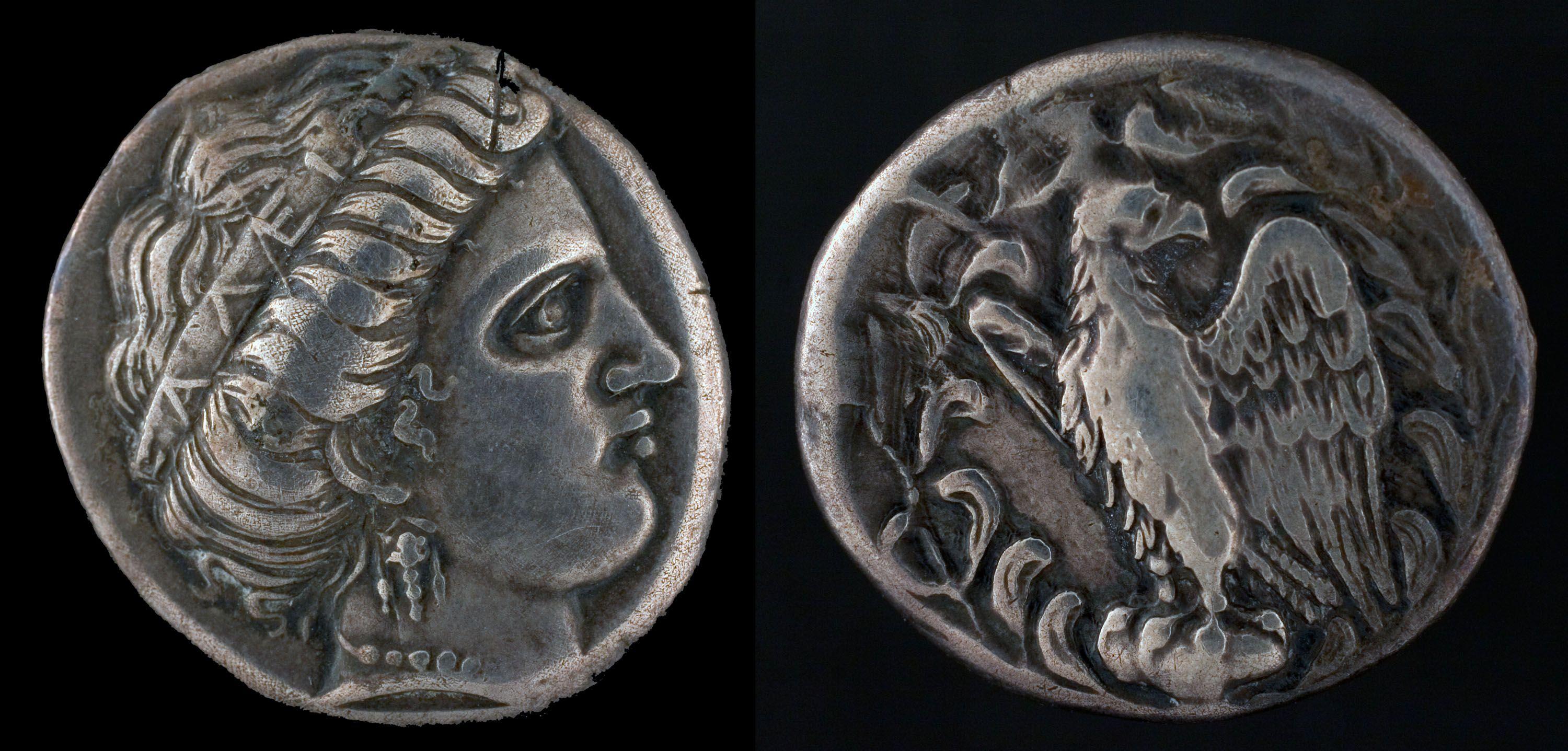 Ancient Greek silver stater from Olympia minted at the Temple of Hera circa 421 BCE. The front side of the coin showcases a profile of Hera adorned with a crown inscribed with "of the Eleains" . The other side displays an eagle.